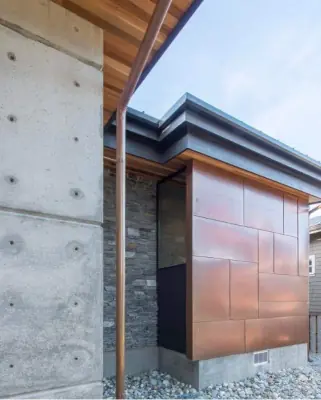 Professional metal roofing installation on a residential property with modern architectural design