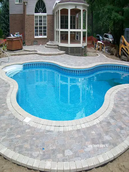 Professional pool installation and maintenance services showcasing a beautiful swimming pool with custom tile work