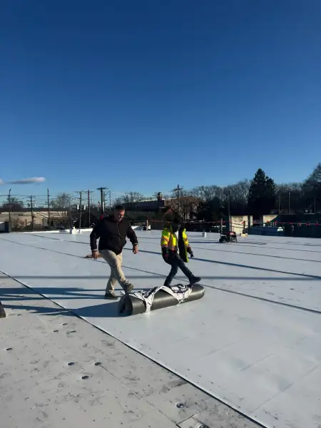Professional flat roofing installation using TPO, EPDM, and PVC materials on a commercial building