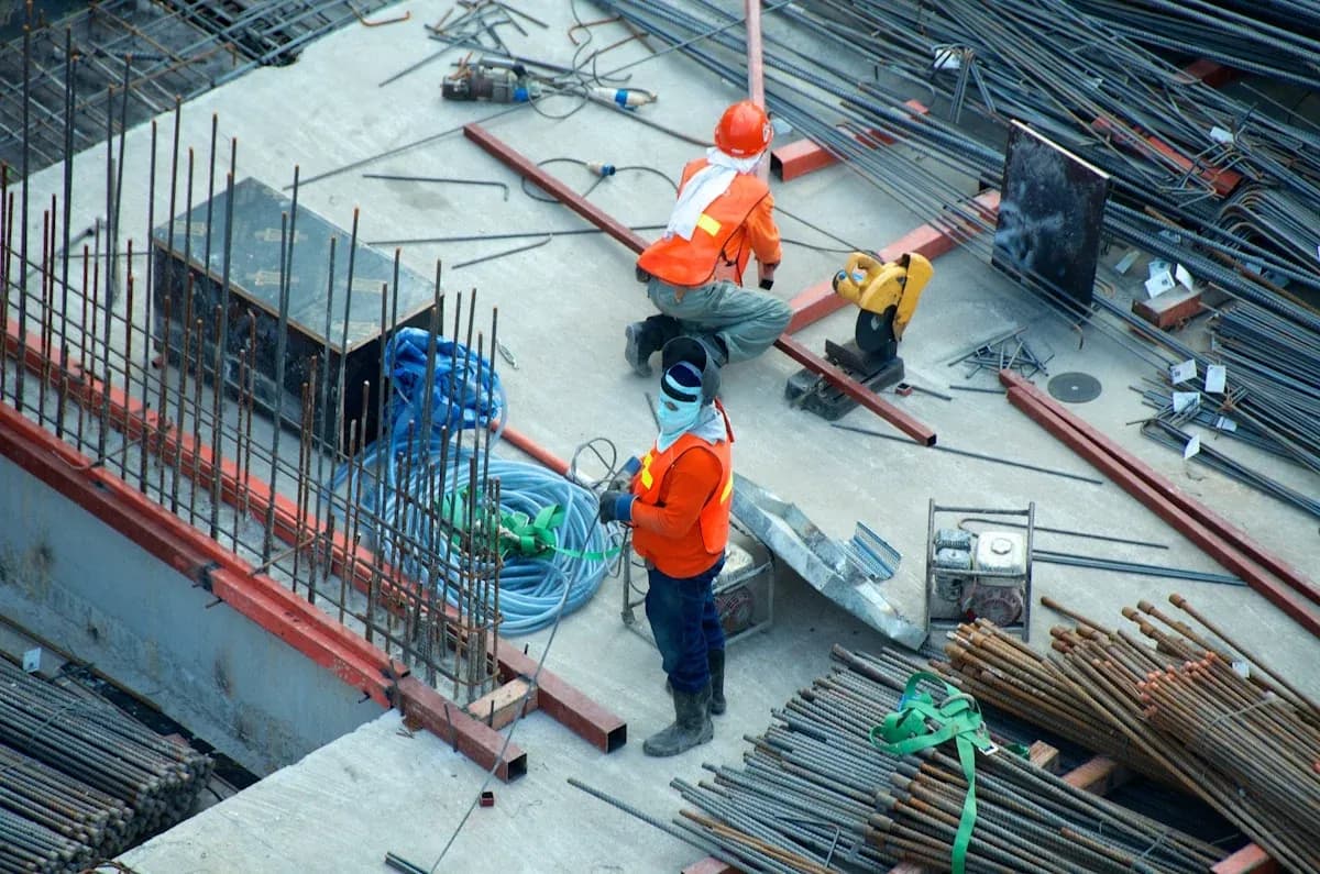 Custom metal roofing fabrication detail showing precision-cut aluminum panels in Genc Construction shop